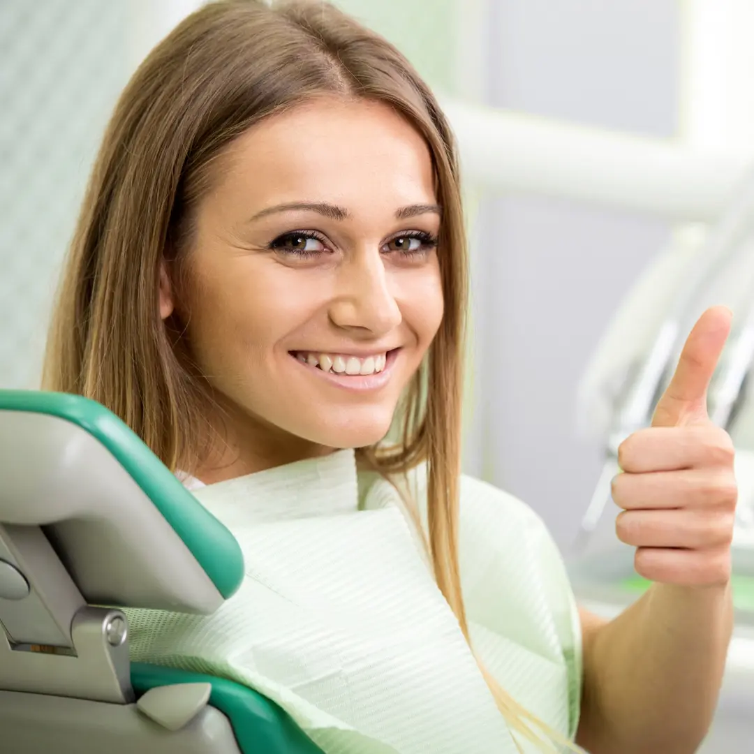 female patient smiling during her visit at a restorative dentist in Mansfield